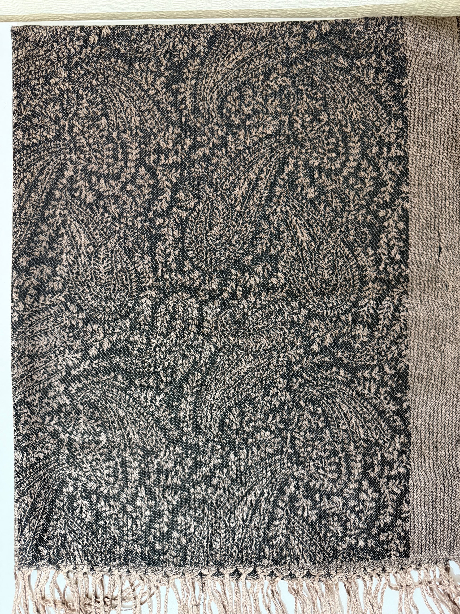 Black pashmina hijab folded on white background — soft lightweight fabric