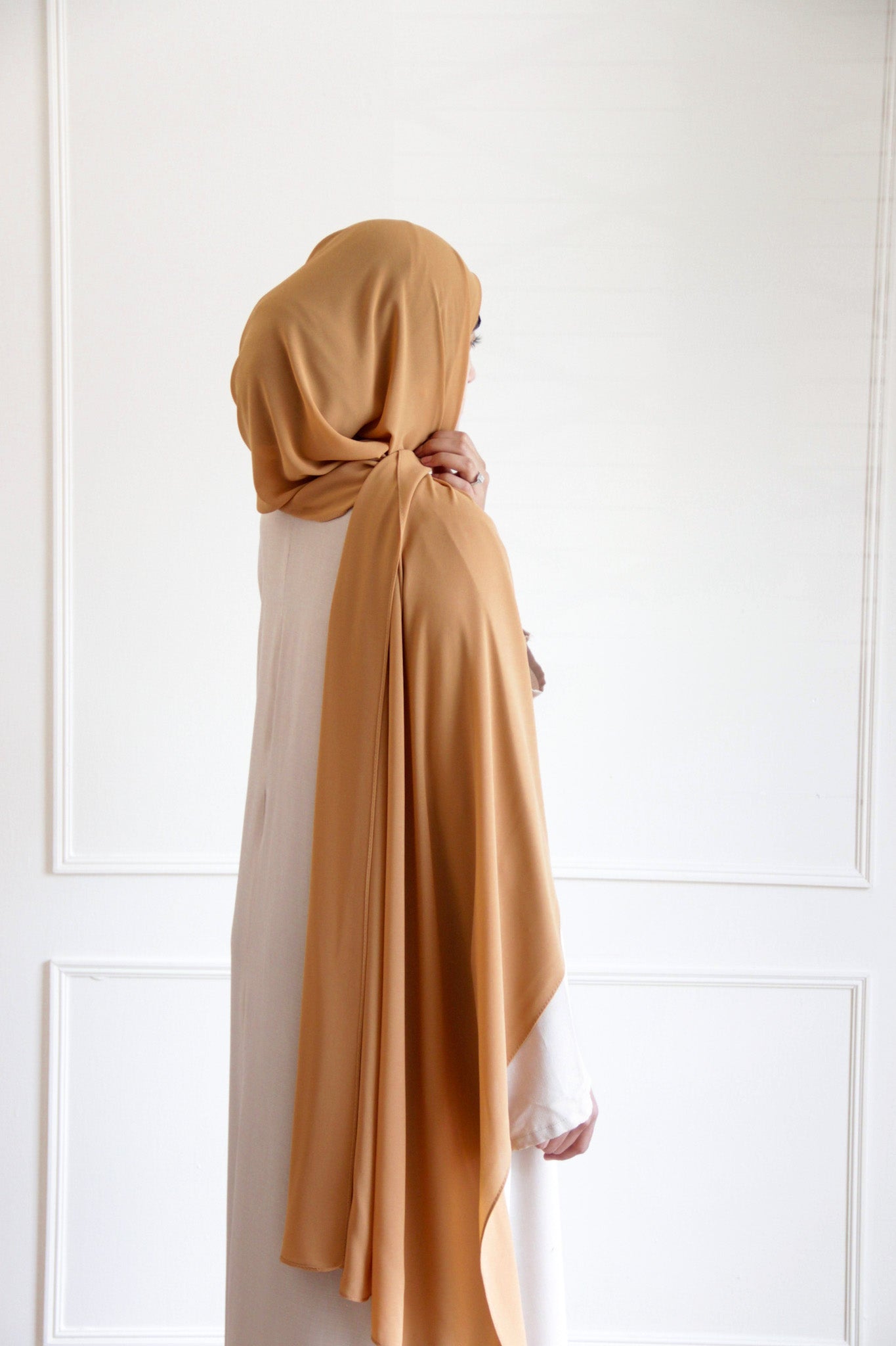 Premium chiffon hijab in Dark Gold – rich golden hue with a smooth, flowing drape for an elegant, luxurious finish