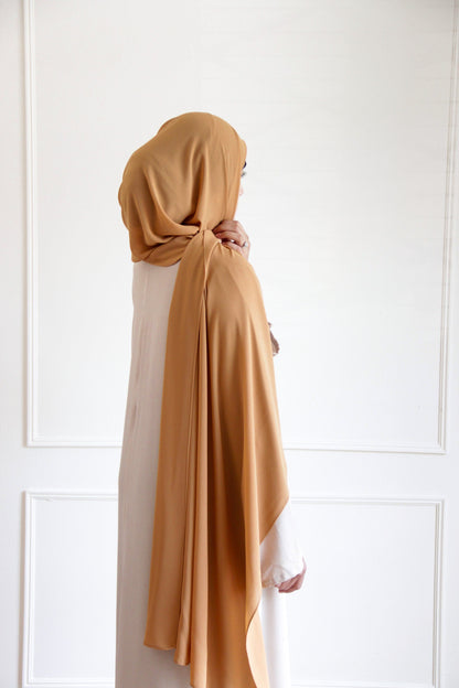 Premium chiffon hijab in Dark Gold – rich golden hue with a smooth, flowing drape for an elegant, luxurious finish